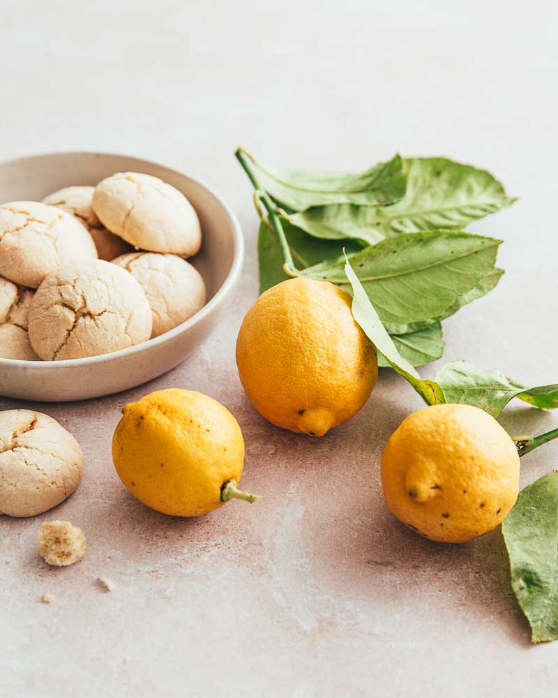 Petit plat de biscuits au citron et à côté 3 citrons jaunes bio non traités