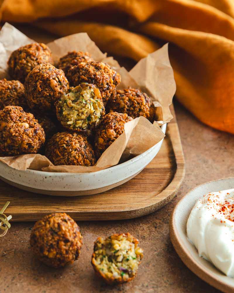 Bol de falafels maison réchauffés à l'air Fryer et servis avec une sauce blanche au yaourt.