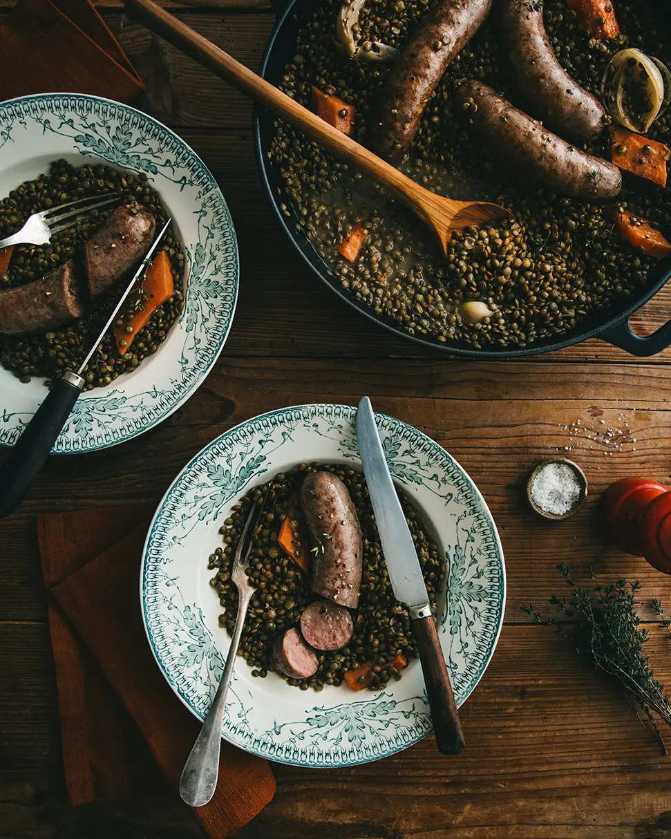 Assiettes de saucisses de sanglier aux lentilles dans une ambiance rustique